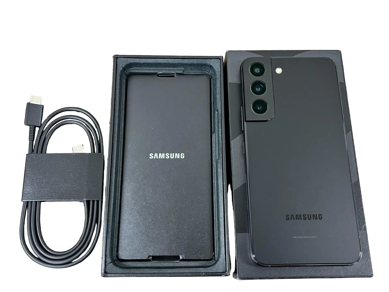 Samsung phone with packaging, cable, and adapter 